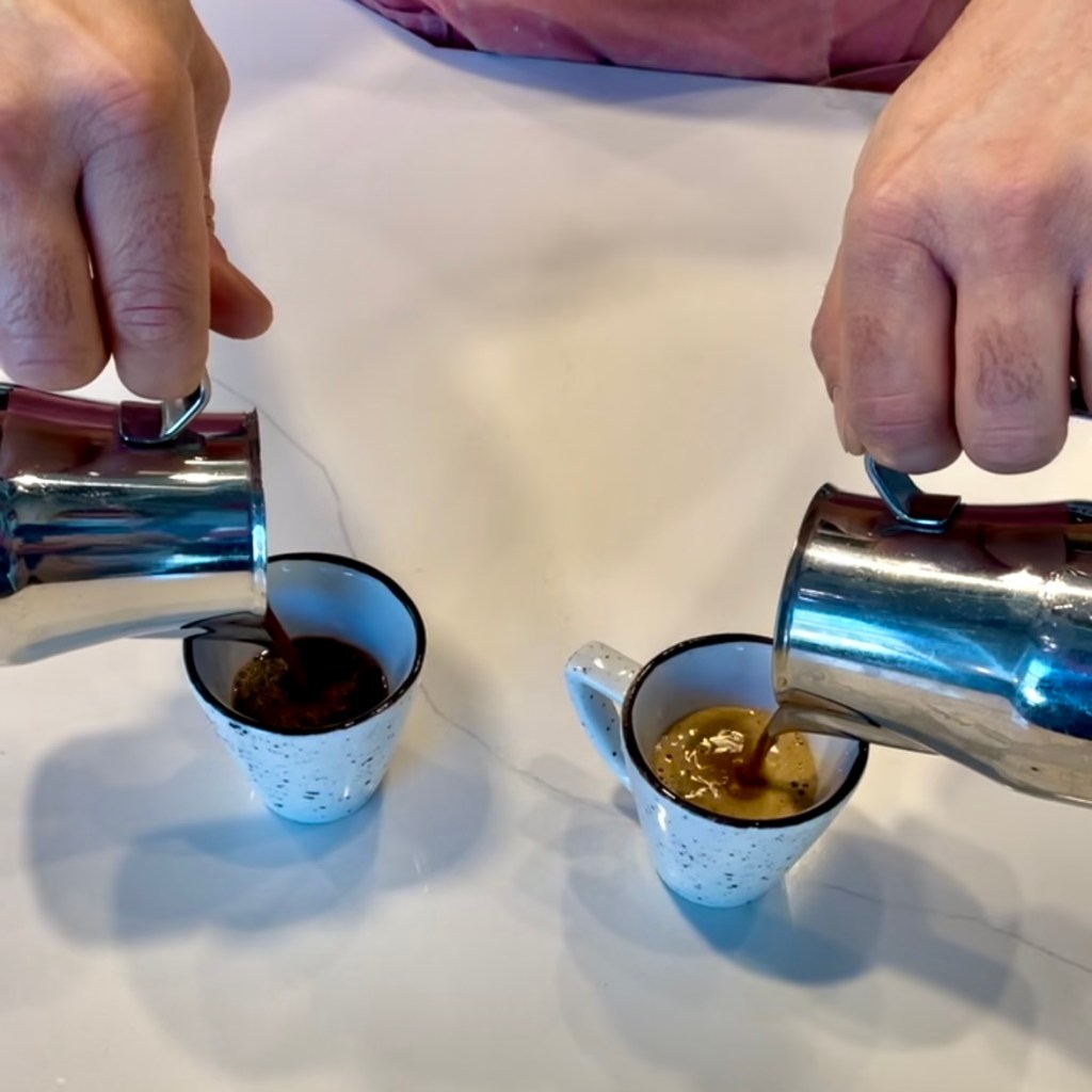 Barista at Ten by Bar Nine pouring two espresso based drinks by hand at the same time simultaneously 